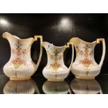 Three 19th C Crown Devon graduated pottery jugs, largest 21cm.
