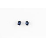 A pair of 14ct white gold stud earrings set with oval cut sapphires, L. 0.4cm.