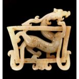 A very fine Qing Dynasty Chinese mottled mutton fat jade dragon amulet, W. 8cm.