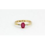 A 9ct yellow gold ring set with an oval cut ruby and diamond set shoulders, (M.5).