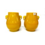 A superb pair of Chinese Imperial yellow Peking glass vases with elephant head handles, H. 28cm.