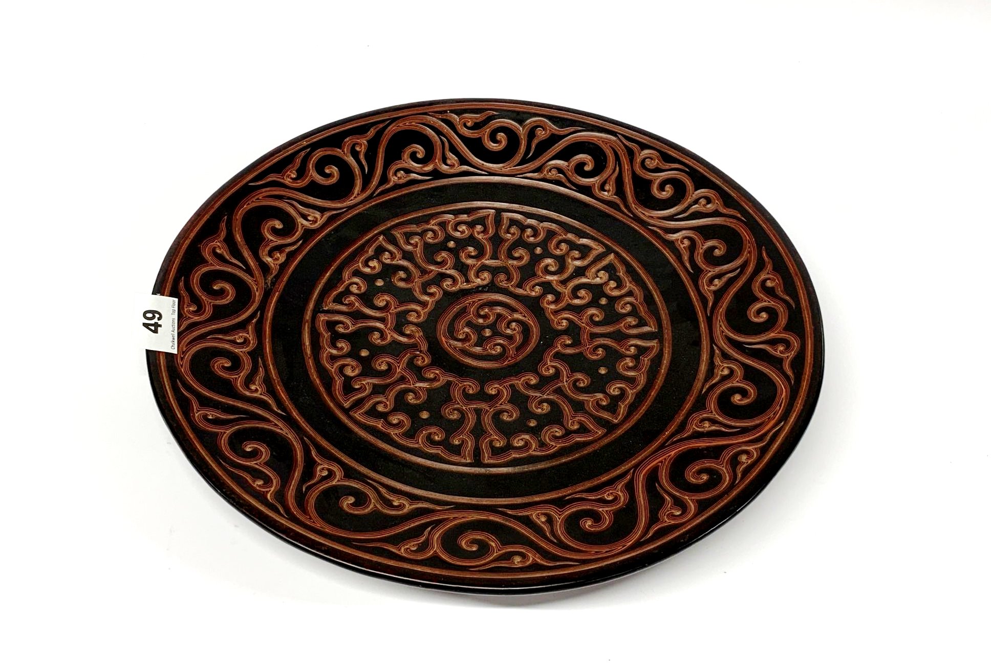 An unusual Chinese two colour carved cinnabar lacquer charger, Dia. 35cm.