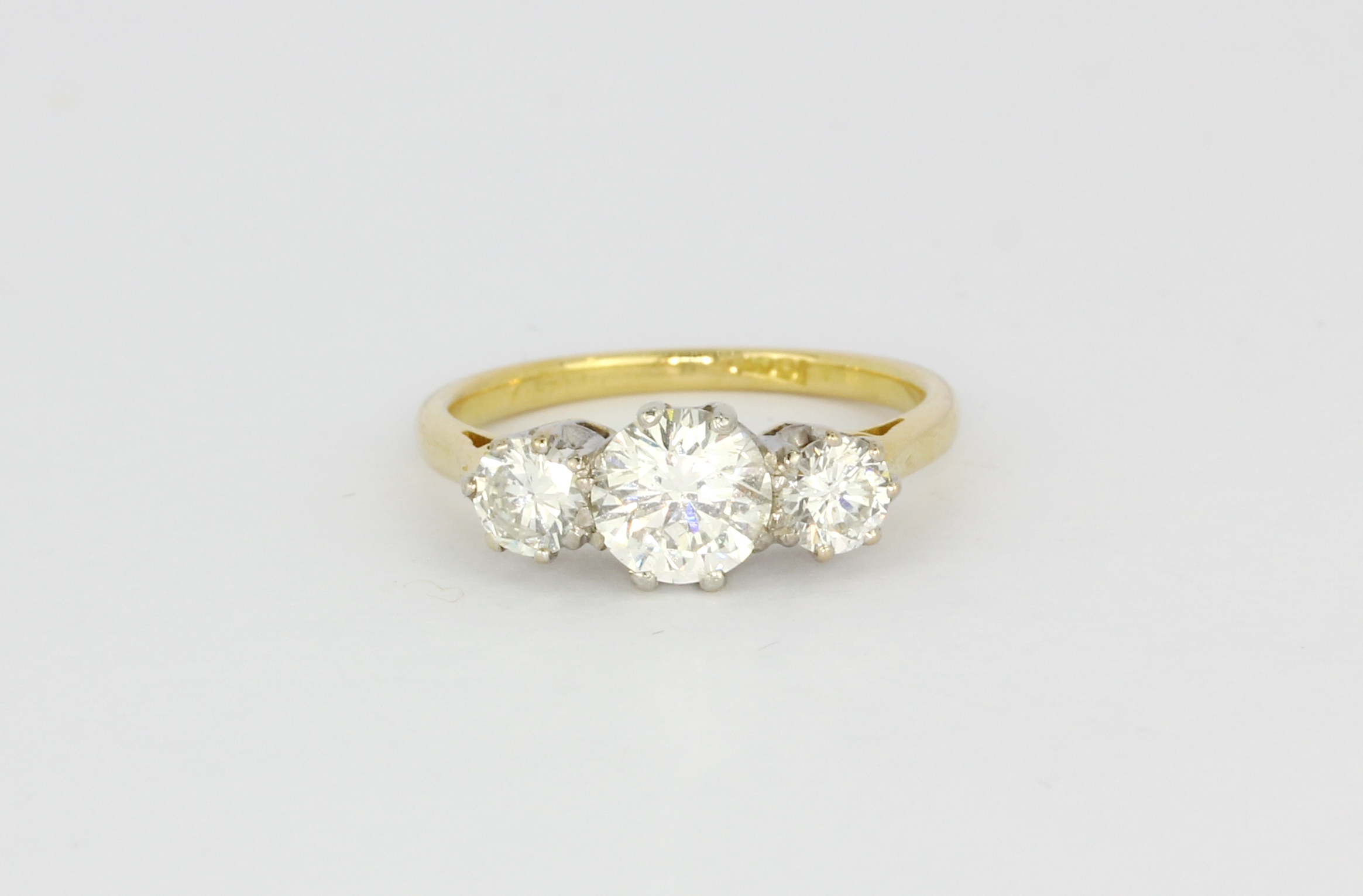 An 18ct yellow gold trilogy ring set with three brilliant cut diamonds, centre stone approx. 1.20ct,