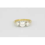 An 18ct yellow gold trilogy ring set with three brilliant cut diamonds, centre stone approx. 1.20ct,