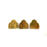 Three 19th/ early 20th Century Tibetan sun baked clay Buddhist devotional tablets, H. 5cm.