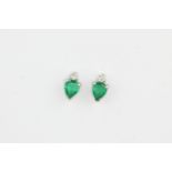 A pair of 14ct white gold stud earrings set with pear cut emeralds and brilliant cut diamonds, L.