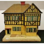 A vintage hand made wooden dolls house with tin windows, 50cm x 60cm x 64cm.