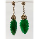 A pair of unusual Chinese white metal mounted carved jade earrings, L. 9.5cm.