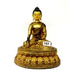A Sino-Tibetan temple quality gilt and hand painted bronze figure of the Buddha seated on a double