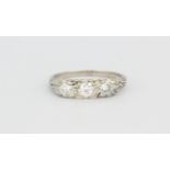 A white metal (tested 18ct gold) ring set with brilliant cut diamonds, approx. 0.70ct, (N).