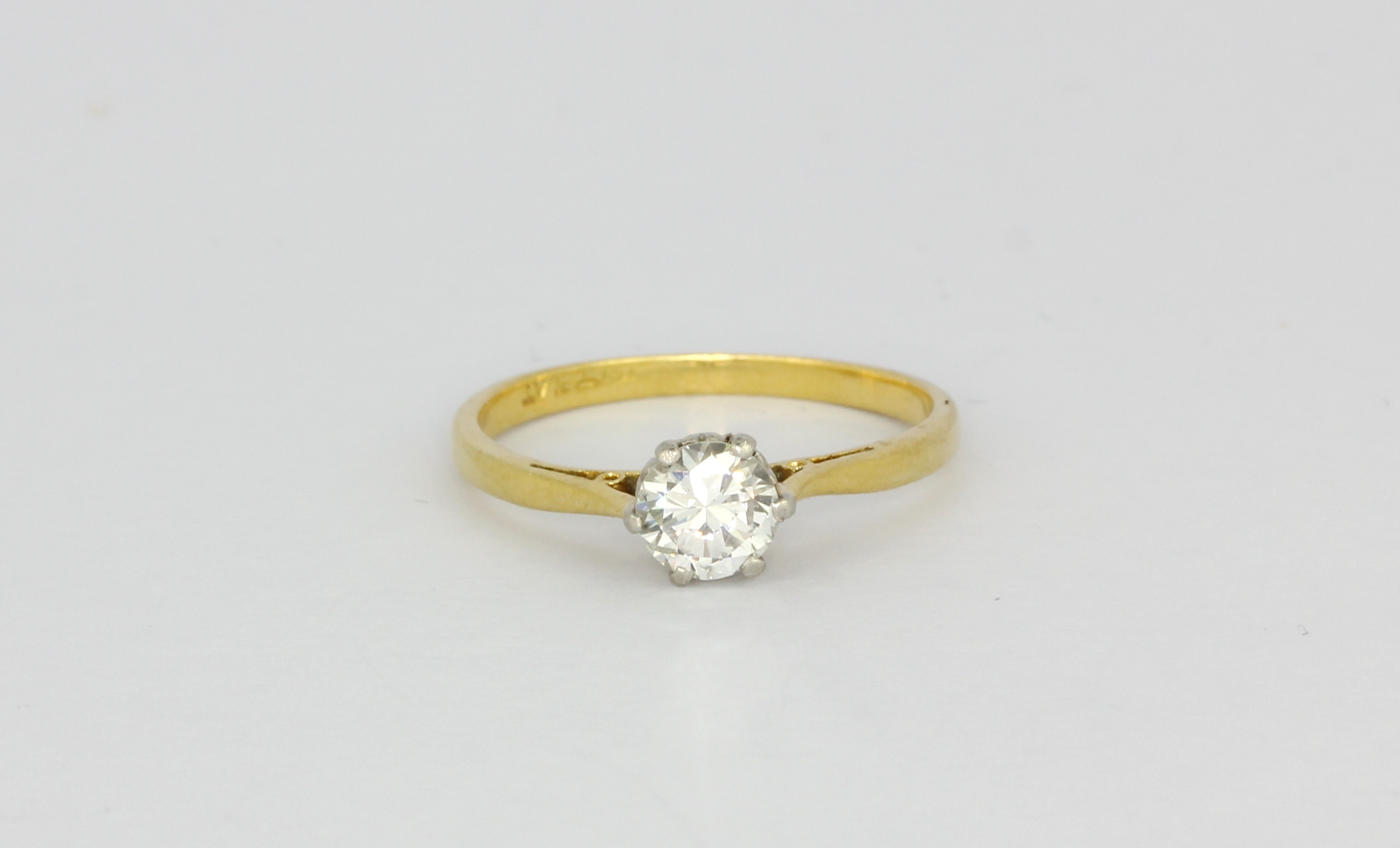 An 18ct yellow gold and platinum brilliant cut diamond set solitaire ring, approx. 0.57ct, (O.5).