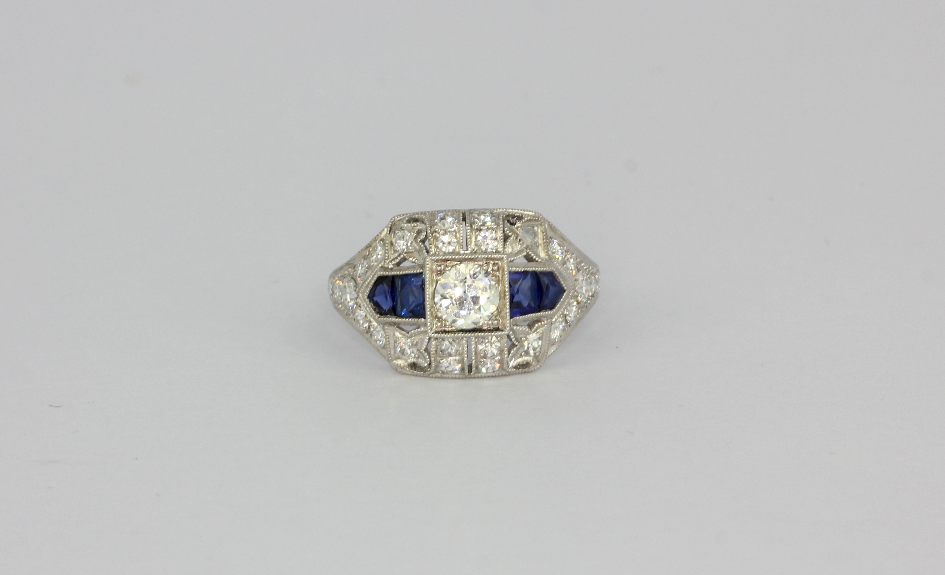 An Art Deco style platinum sapphire and diamond set ring, (M.5).