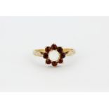 A 9ct yellow gold opal and garnet set cluster ring, (O).
