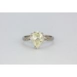 A platinum ring set with a 1.91ct pear cut diamond flanked by trillion cut diamonds, (N).