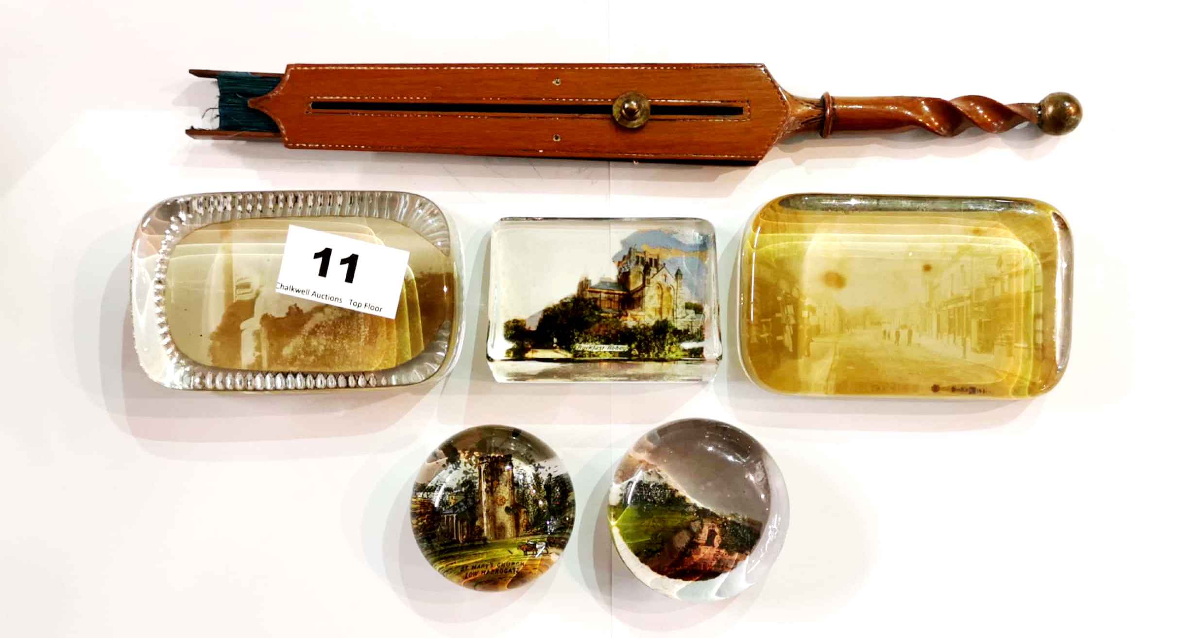 A group of five Victorian and other paper weights and an unusual wood and paper fan with turned