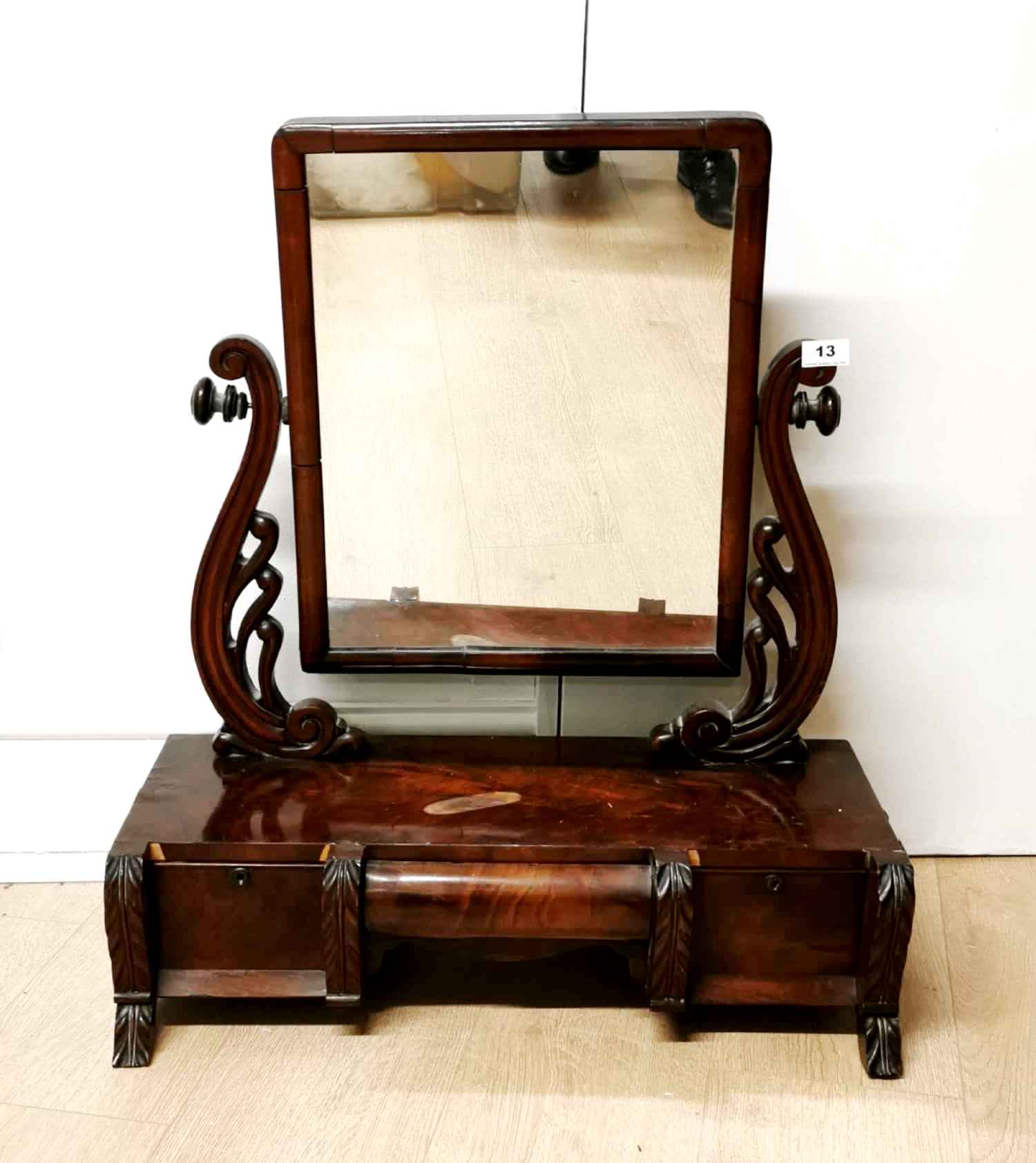 An early 19th C. mahogany veneered dressing mirror with three drawers, H. 74cm.