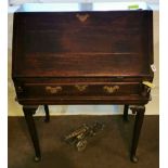 A late 18th C oak clerks desk with brass fittings with good fitted interior and with a four legged
