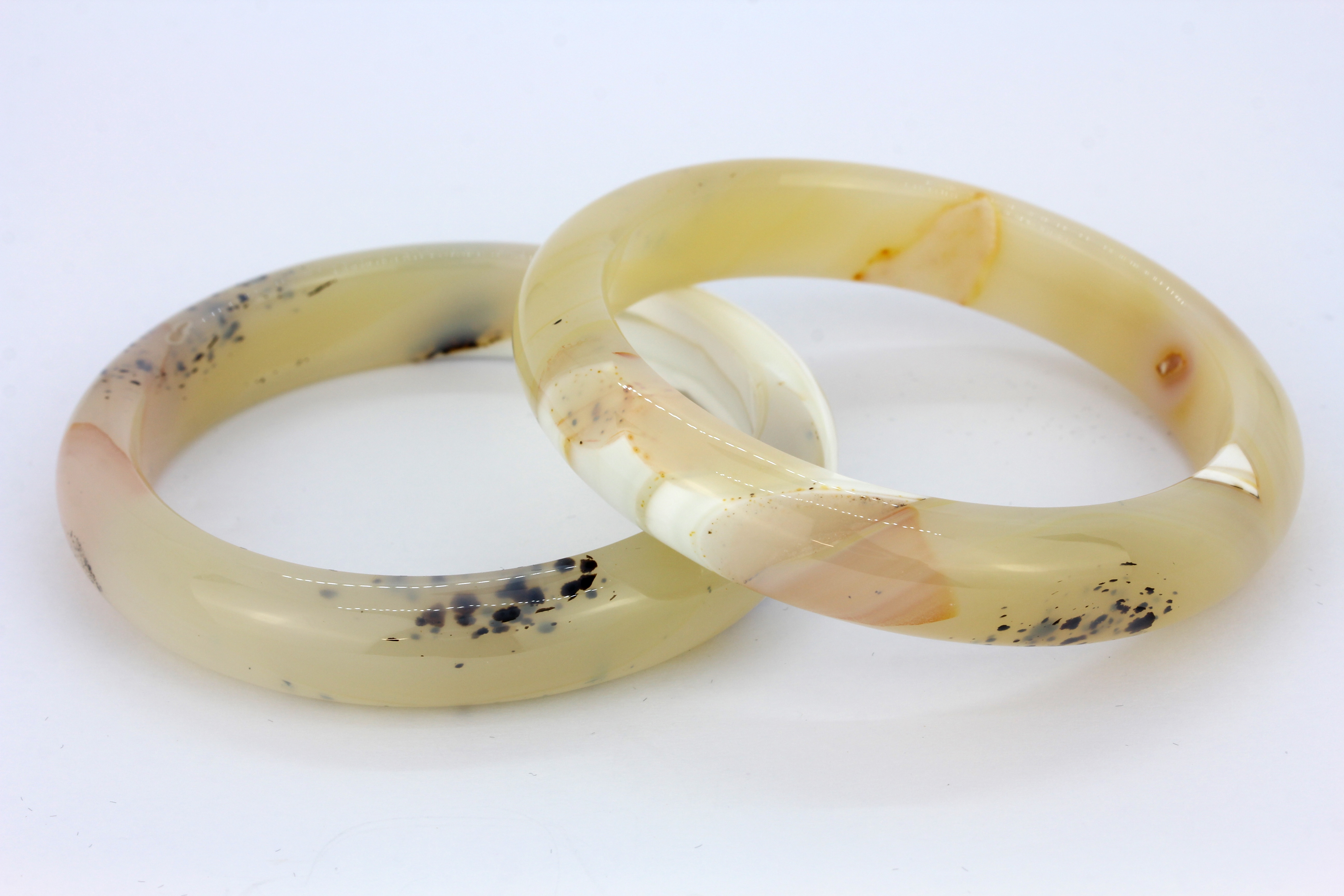 A stunning pair of polished banded and moss agate bangles, W. 12.5mm internal Dia. 6cm.
