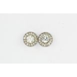 A pair of 18ct white gold diamond set halo earrings, approx. 1ct, Dia. 0.8cm.