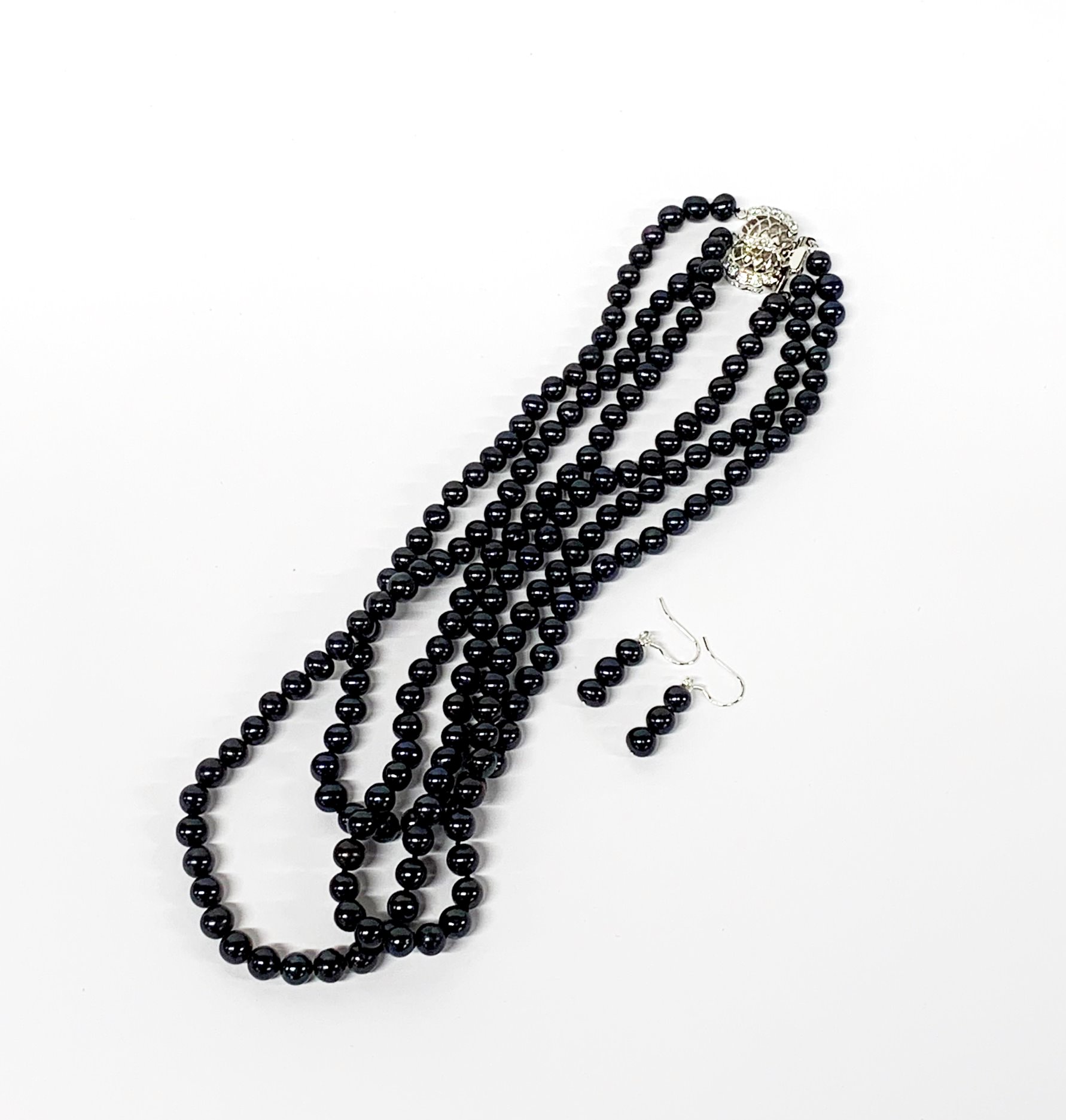 A pretty three row necklace of blue black 6mm cultured pearls, shortest row L. 38cm, together with a