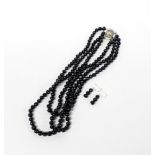 A pretty three row necklace of blue black 6mm cultured pearls, shortest row L. 38cm, together with a