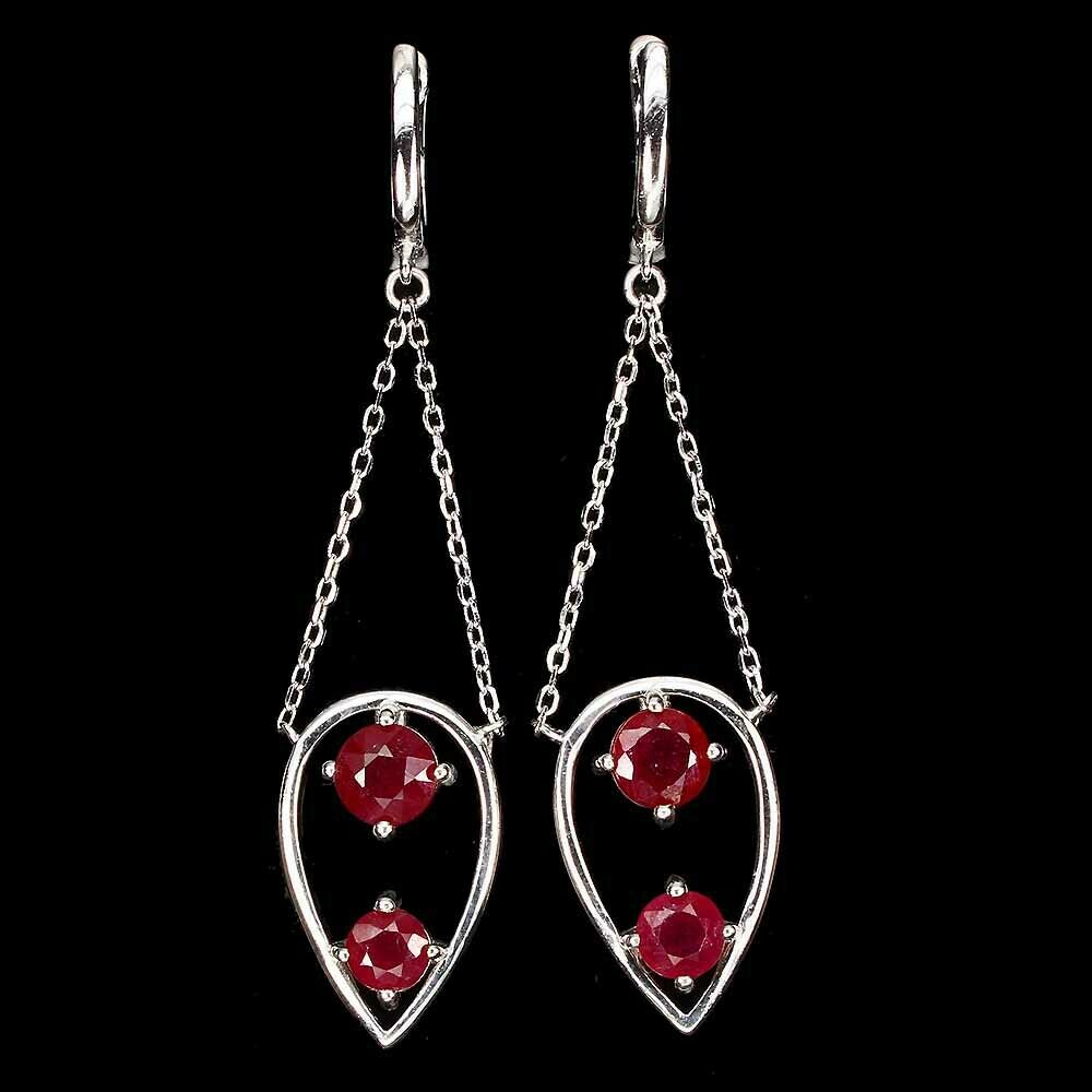 A pair of 925 silver drop earrings set with round cut rubies, L. 6cm.