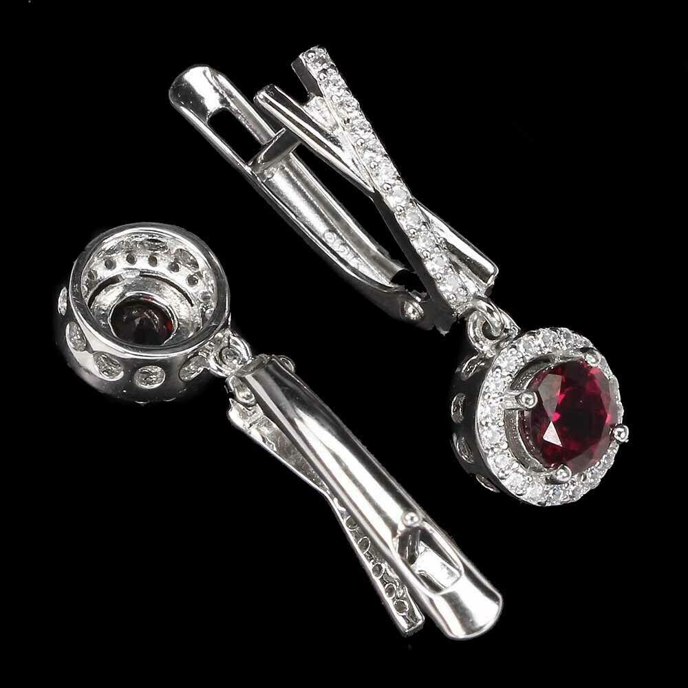 A pair of 925 silver drop earrings set with round cut garnets and white stones, L. 2.3cm. - Image 2 of 2