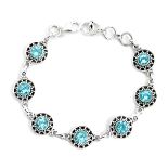 A 925 silver bracelet set with swiss cut blue topaz, L. 20cm.