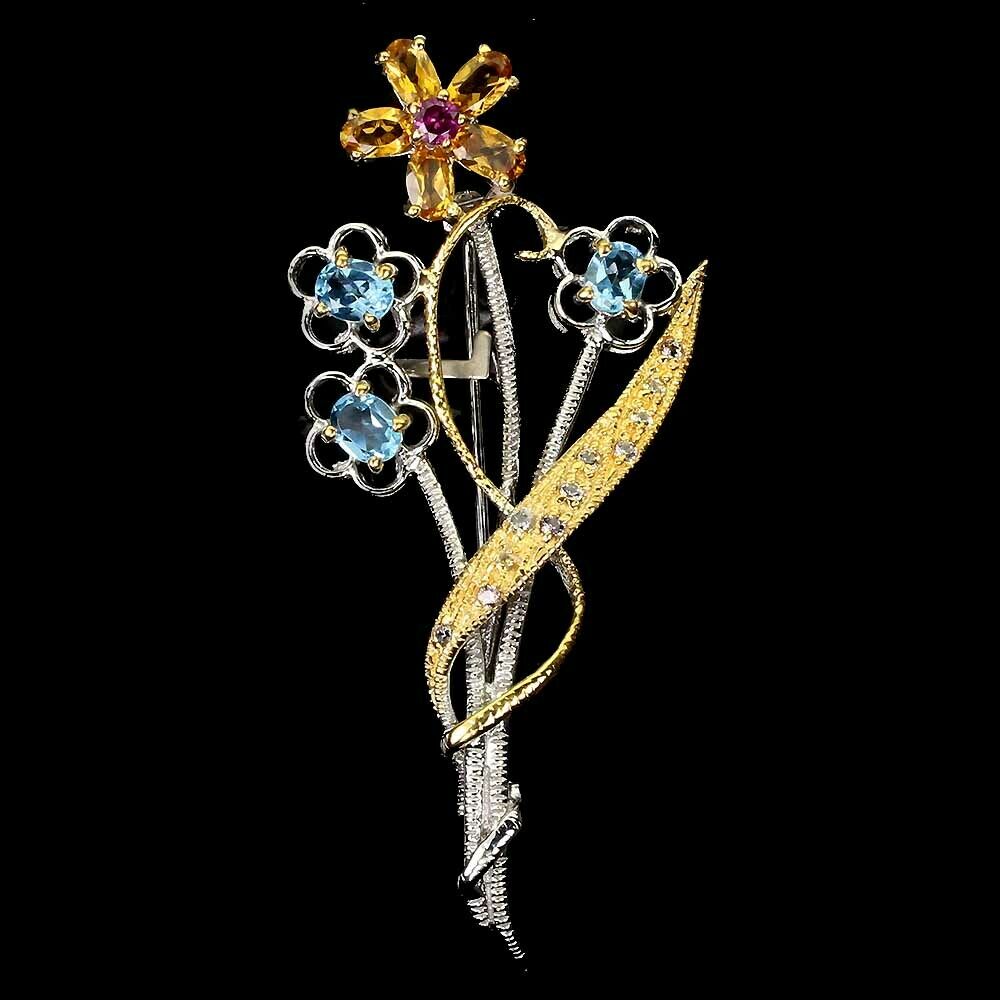 A 925 silver gilt flower shaped brooch set with blue topaz, citrine and rodolite garnets, L. 6cm.