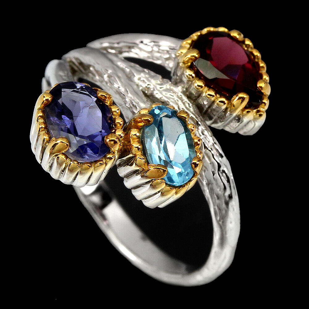 A 925 silver ring set with garnet, tanzanite and blue topaz. - Image 2 of 2