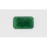 An unmounted emerald cut emerald, L. 0.8cm, approx. 5.2cm.