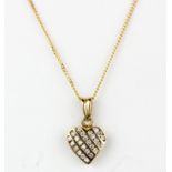A 9ct yellow gold diamond set heart shaped pendant and chain, L. 2cm.
