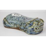 A Chinese hand painted porcelain pillow in the shape of a recumbent tiger, L. 18cm. H. 5cm.