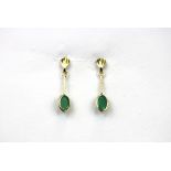 A pair of 9ct yellow gold drop earrings set with oval cut emeralds, L. 2cm.