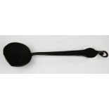 A Tibetan 19th C. hammered iron ladle, L. 23cm.