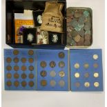 A tin and box of mixed coins, books of coins, stamps and other items.