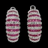 A pair of 925 silver earrings set with round cut rubies and white stones, L. 1.7cm.