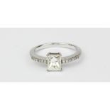 An 18ct white gold (stamped 18k) solitaire ring set with a princess cut diamond and brilliant cut