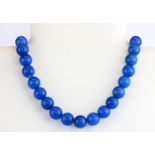 A 9ct yellow gold (stamped 9k) gold and polished chalcedony bead necklace, L. 18cm.