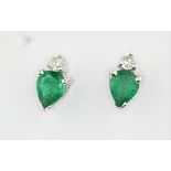 A pair of 14ct white gold (stamped 14k) earrings set with pear cut emeralds and diamonds, L. 0.8cm.