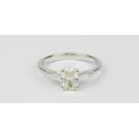 An 18ct white gold (stmaped 750) solitaire ring set with an oval cut diamond set ring, approx. 1.