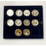 A box containing eight Canadian coins 1oz silver with a further two enamelled coins.