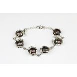 A white metal bracelet set with cultured black pearls and white stones, L. 20cm.