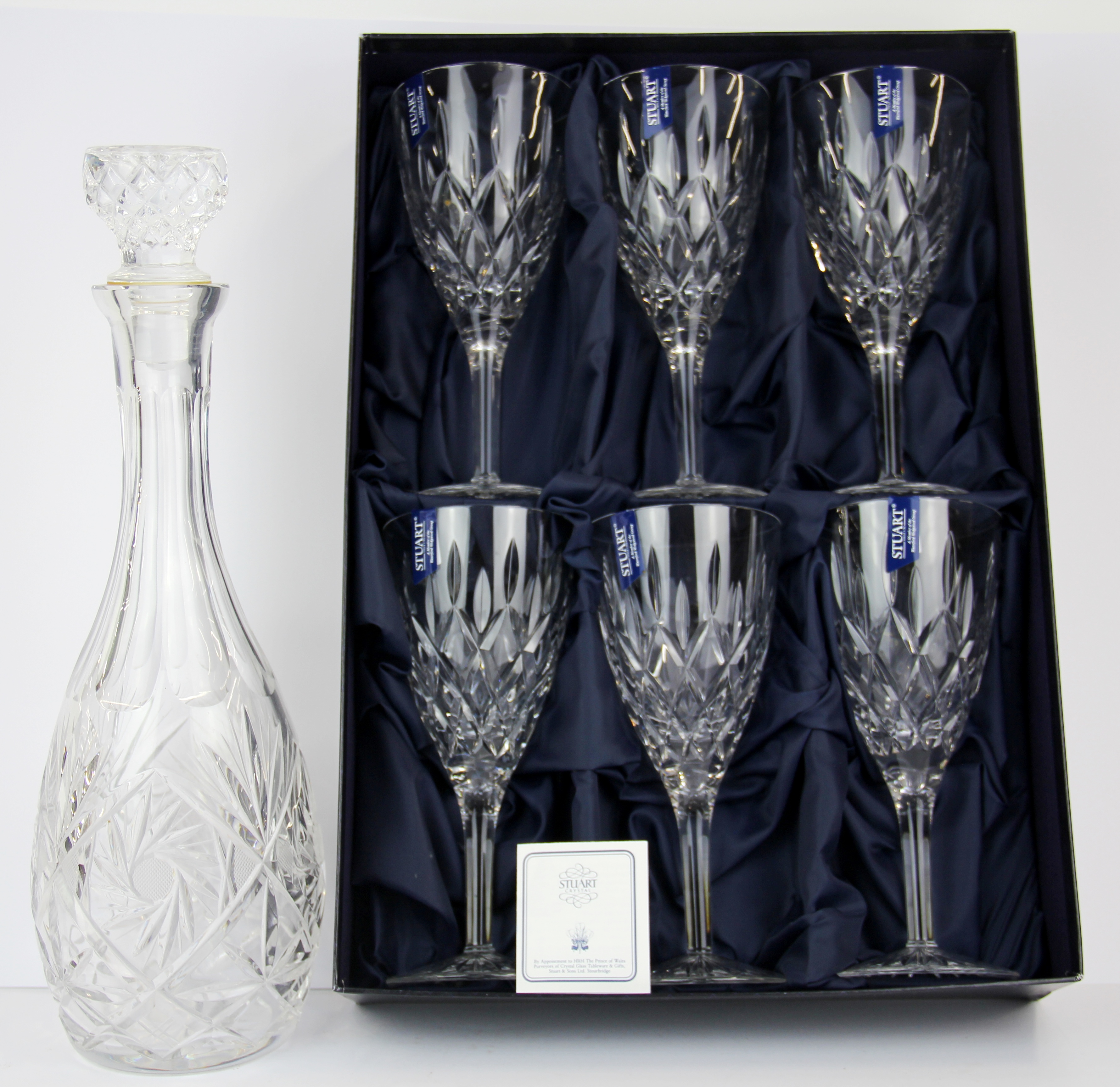 A boxed set of six Stuart crystal wine glasses together with a cut glass decanter.