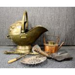 An Art Nouveau hammered brass coal bucket and other fire side items.