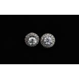 A pair of 18ct white gold diamond set halo earrings, approx. 1ct overall, Dia. 0.9cm.