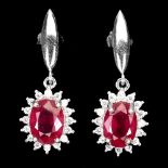 A pair of 925 silver drop earrings set with oval cut rubies surrounded by white stones, L. 2.5cm.