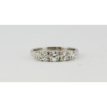 A white metal (tested 18ct gold) ring set with five brilliant cut diamonds, approx. 1ct, (N.5).