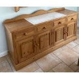 A pine kitchen cabinet with a tile inset top, W. 182cm. H. 82cm.