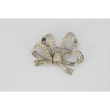 A boxed white metal (tested 18ct gold) diamond set bow shaped brooch, approx. 5.70ct overall, 4.5